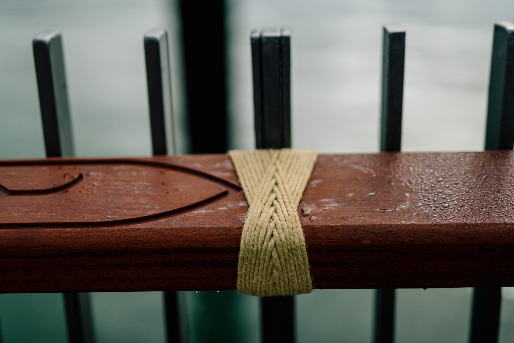 Weaving by Tessa Harris shown on a waterfront handrail