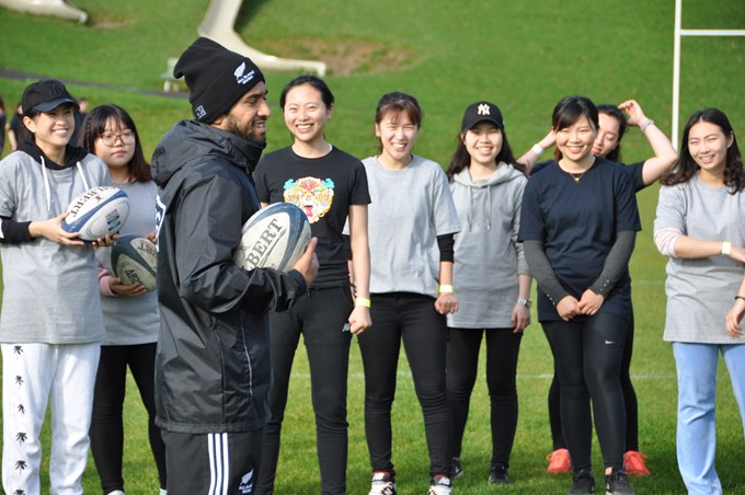International students have a ball learning to play rugby (1)