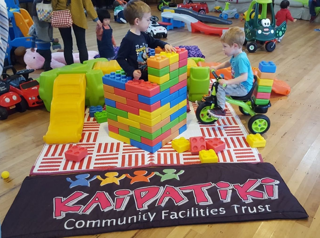 Kids playing with large building blocks. 