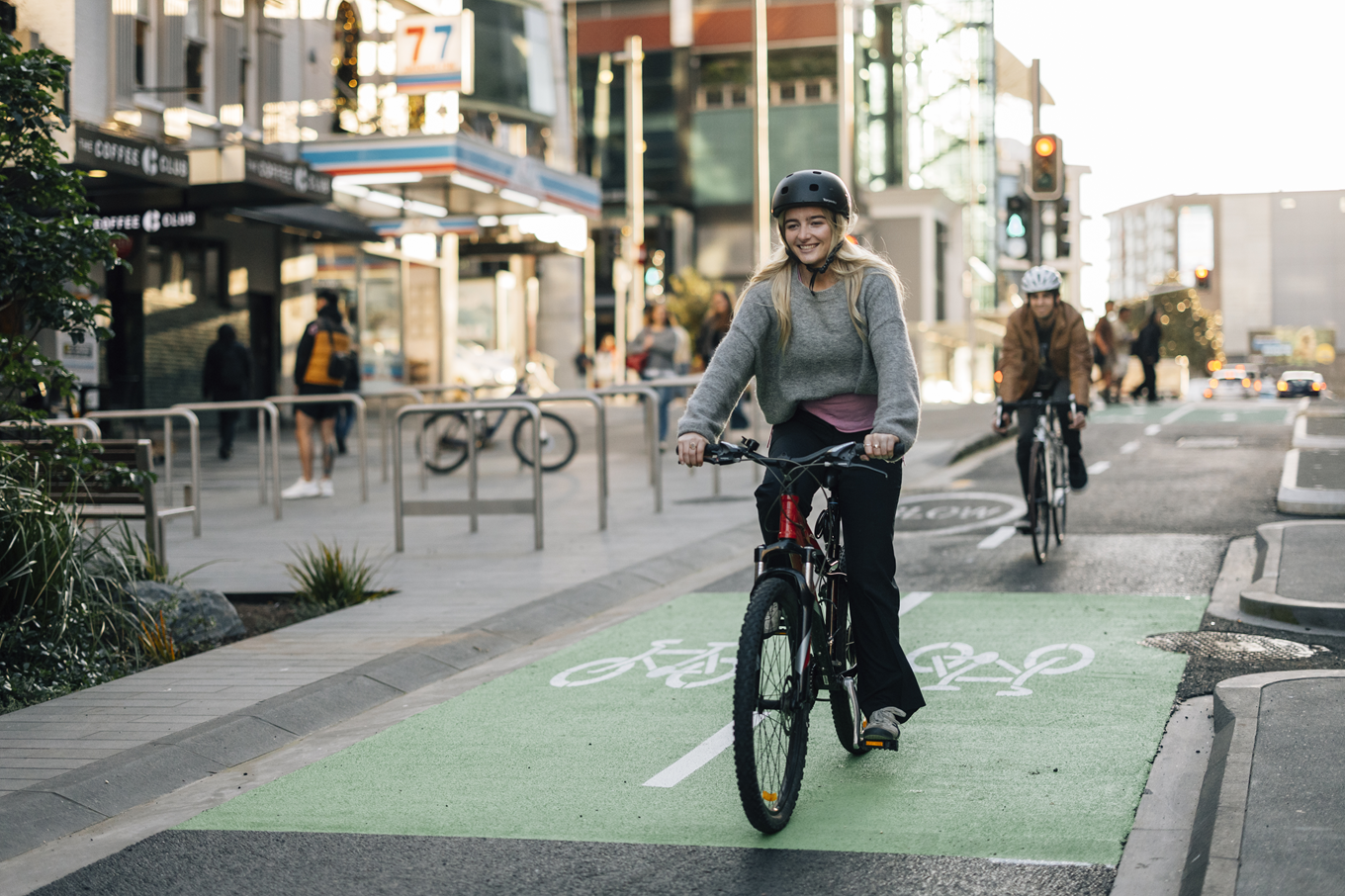 A lady riding a bike down a bike path. 