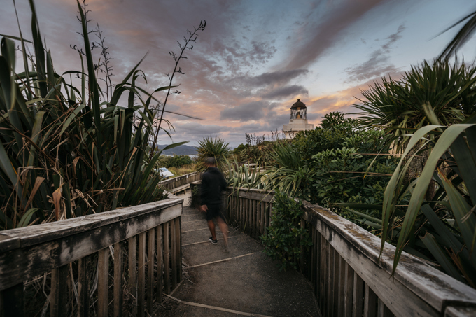 A person walking to the light house