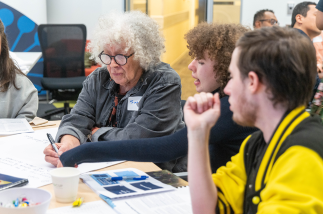 Seniors Advisory Panel member Susanne Tapsell, left, collaborates with Esther O'Donnell from the Youth Advisory Panel and Ashe Black, a Rainbow Communities Advisory Panel member. 