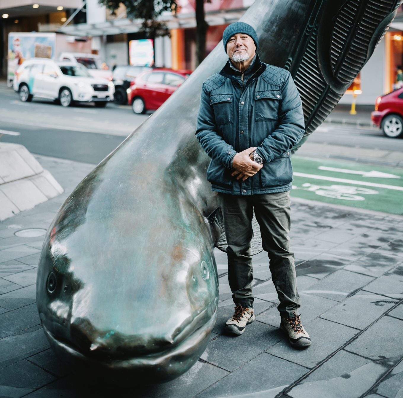 Artist Chris Bailey positioned in front of his art piece in the Auckland City Centre.
