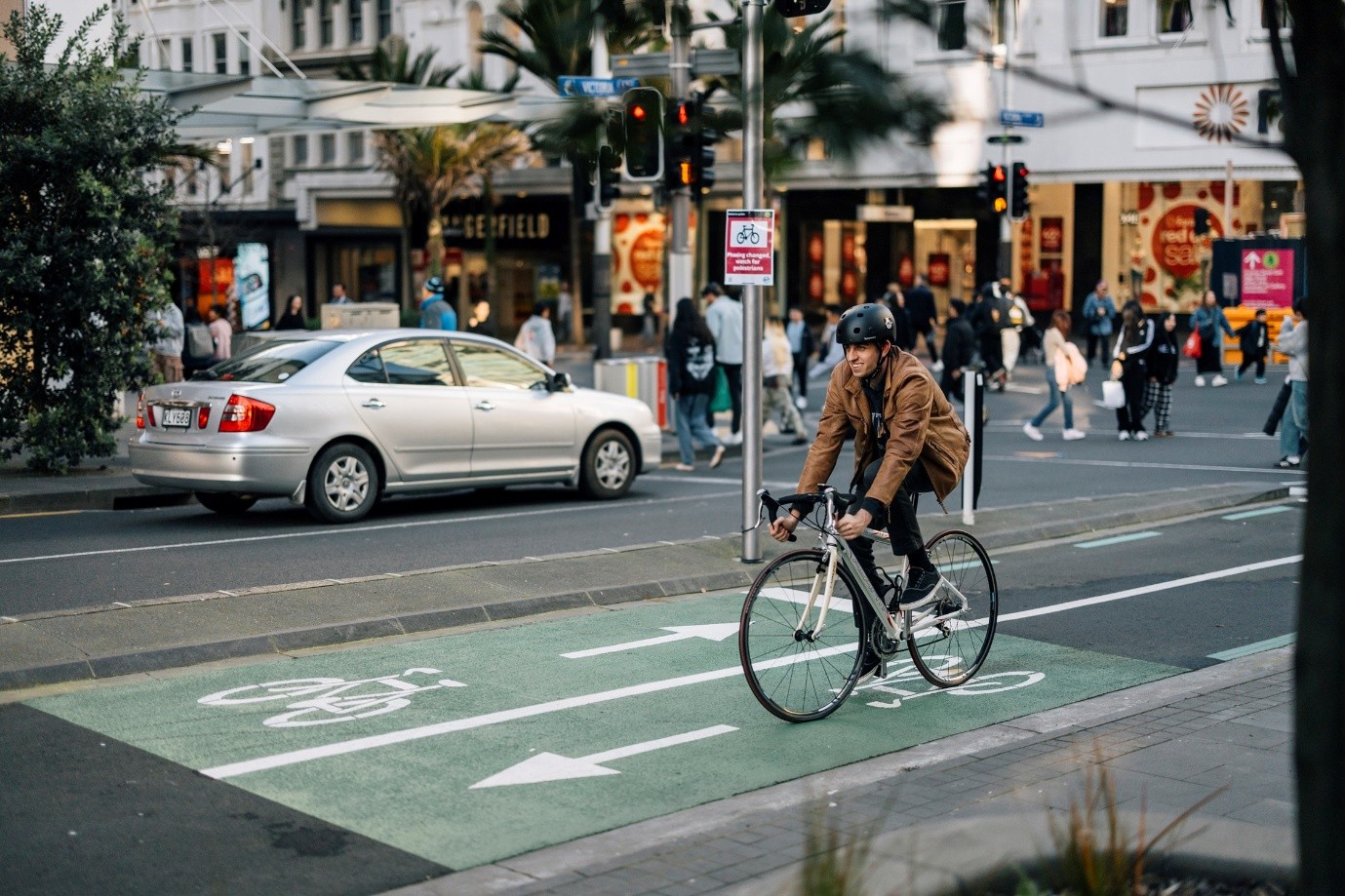 A guy cycling in Auckland City Centre.