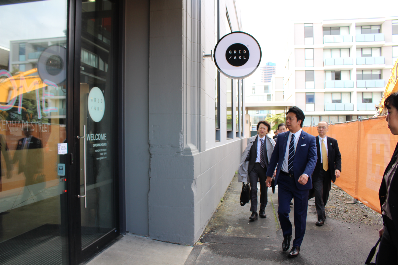 A group of people entering a building. 