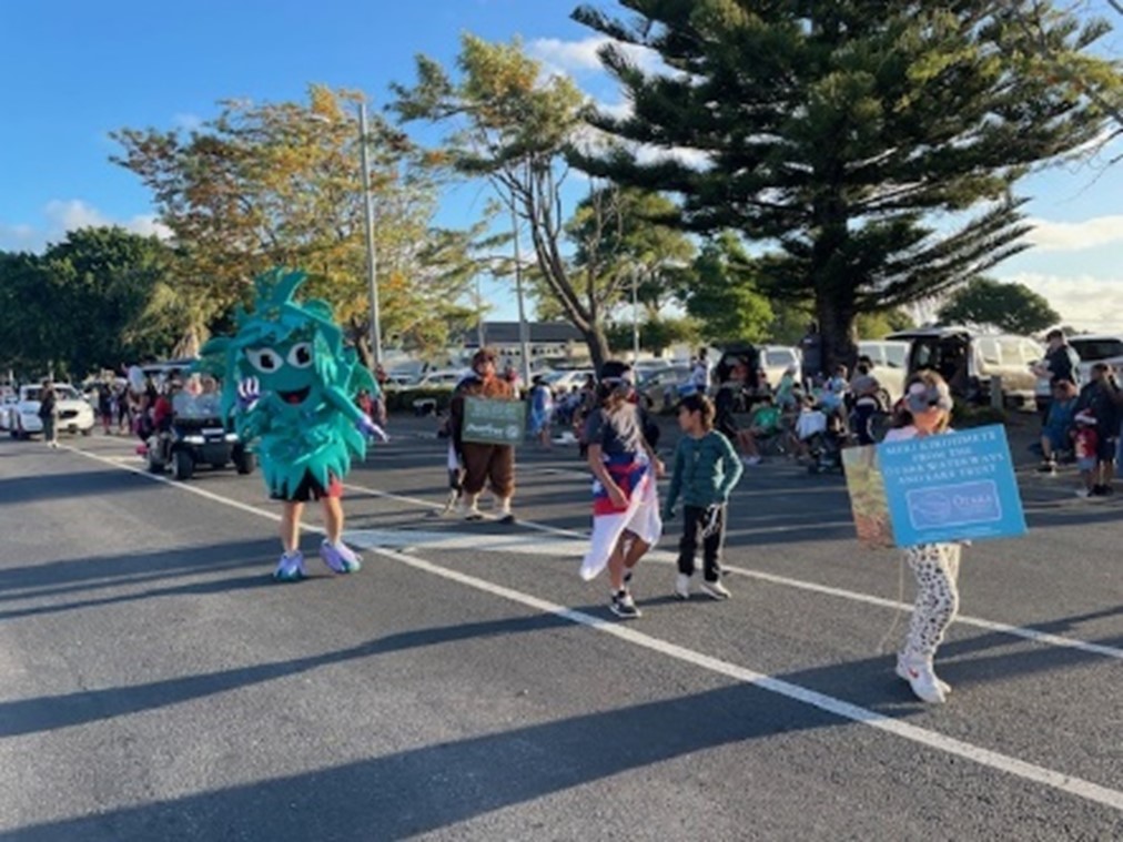 Local parade with mascot and community.