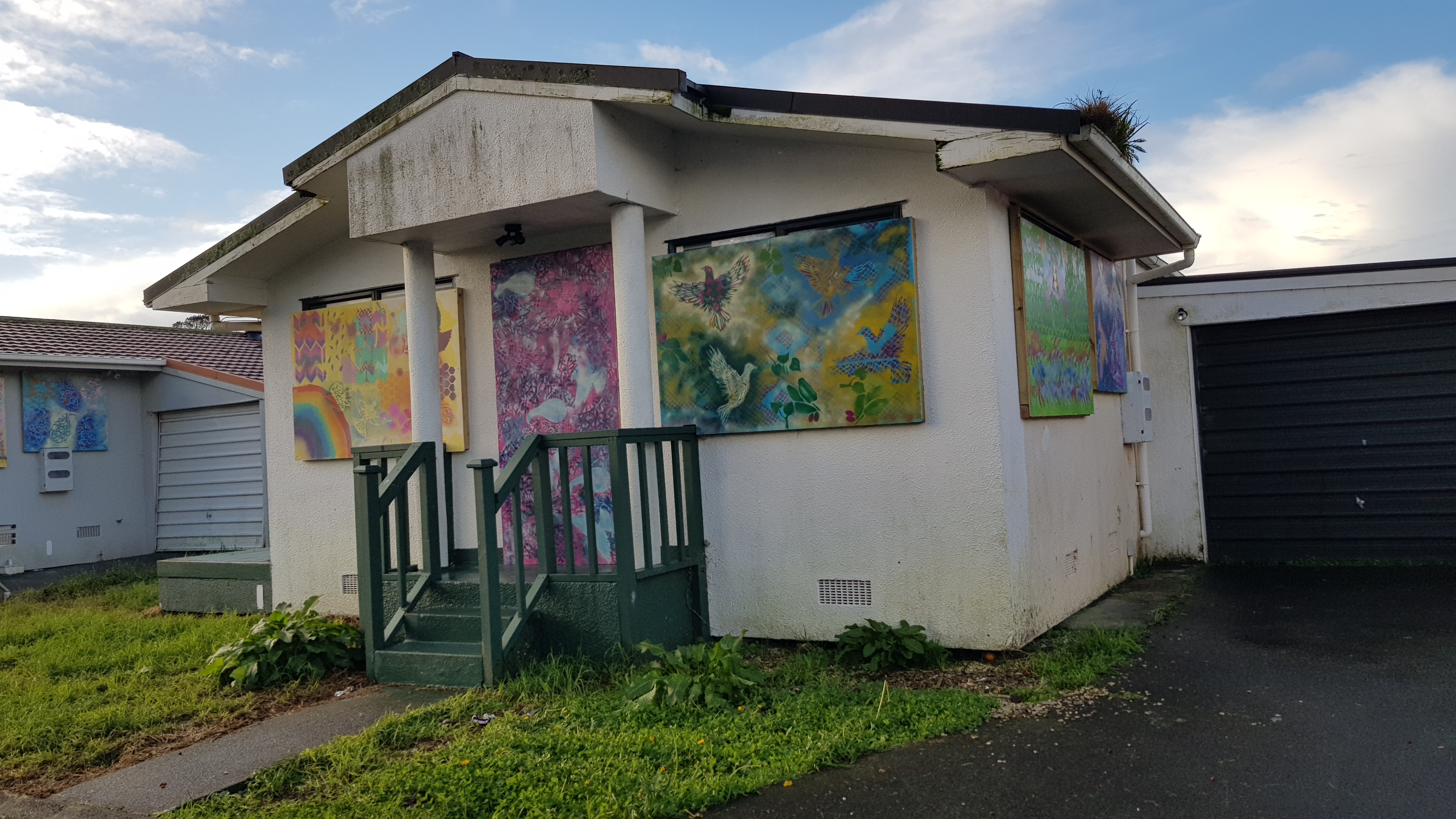 One of the boarded up houses on Clover Drive, decorated with painted boards.