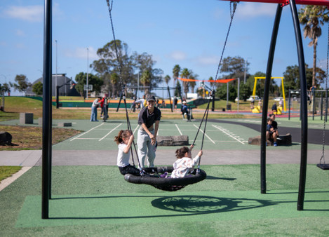 Kids playing on a swing. 