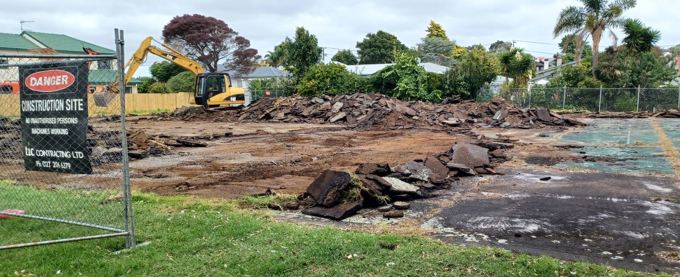 Old tennis court being removed by digger