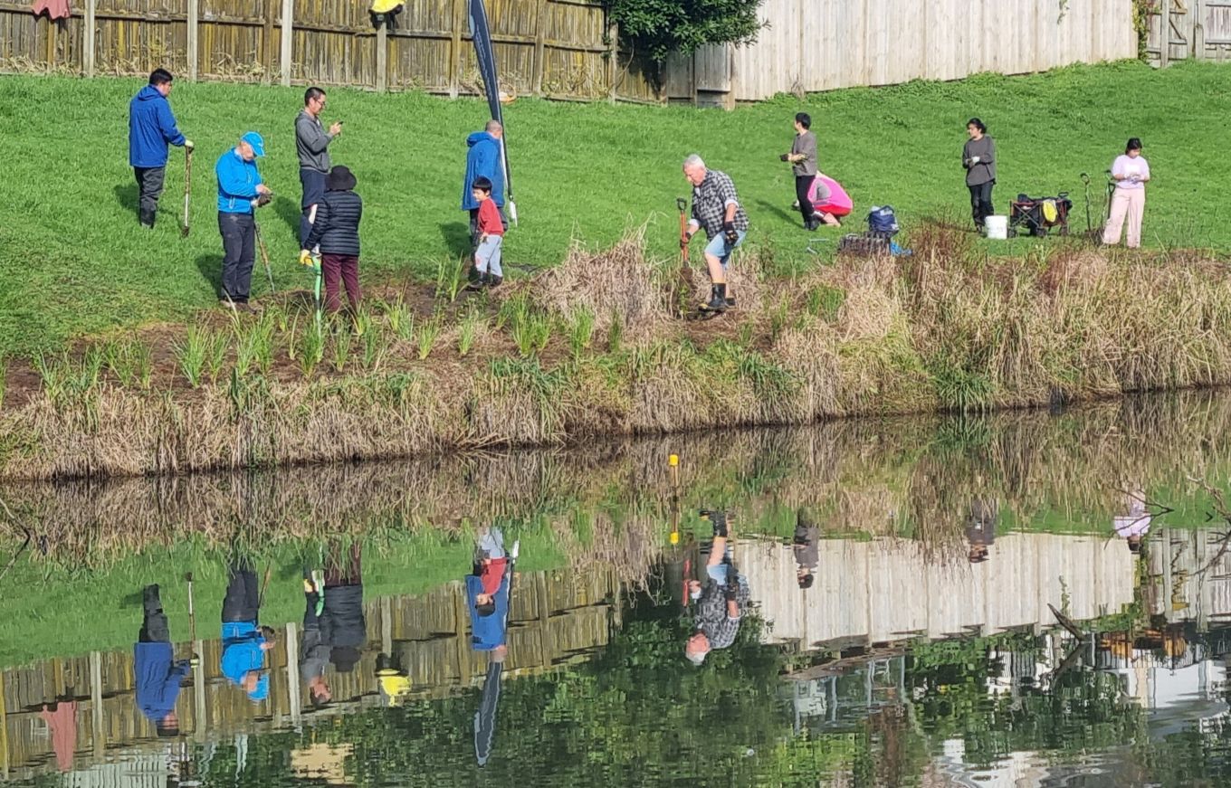Community garden volunteers by the pond. 