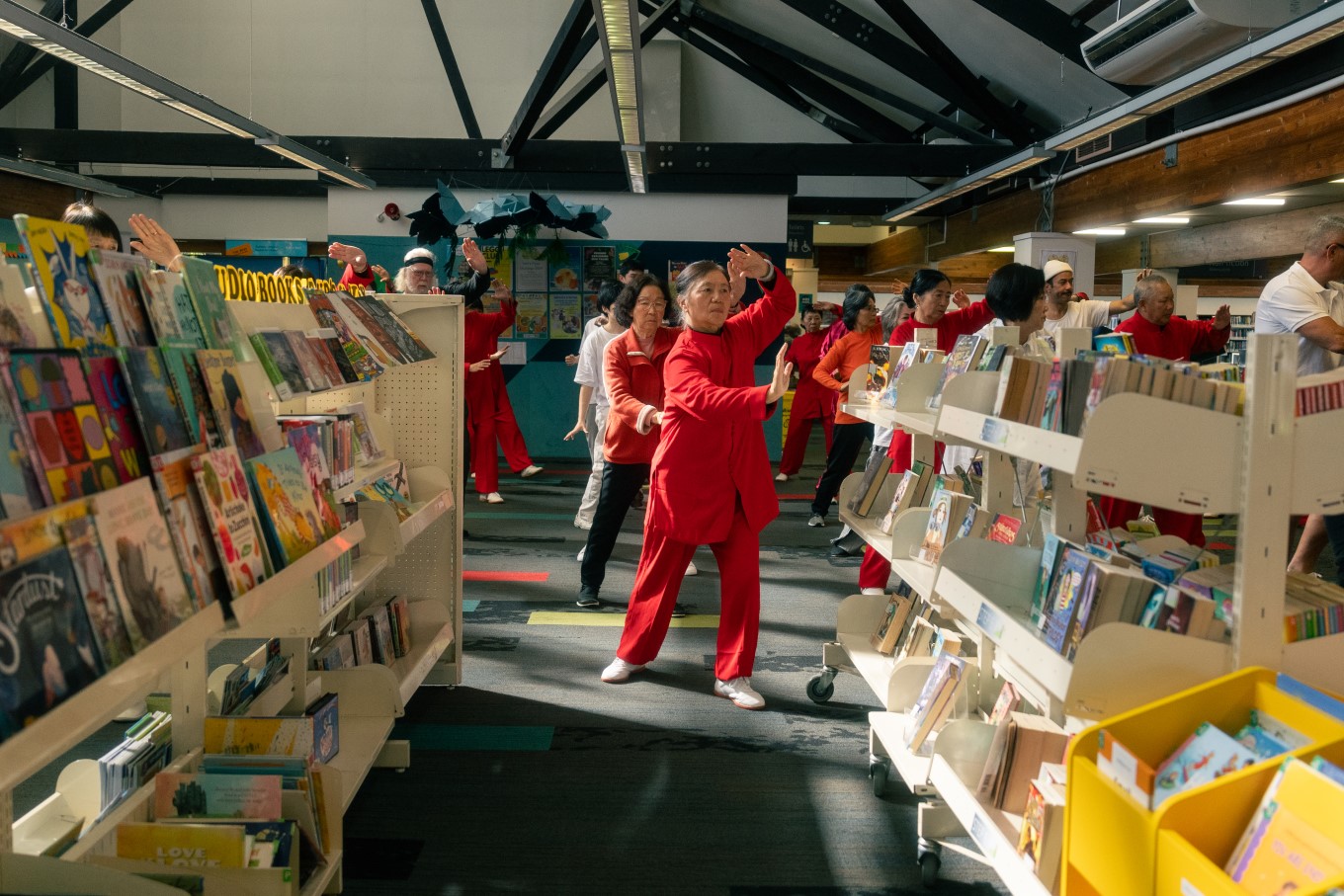 The tai chi class takes place amongst the bookshelves in the children’s area of Mt Albert Library on Mondays.