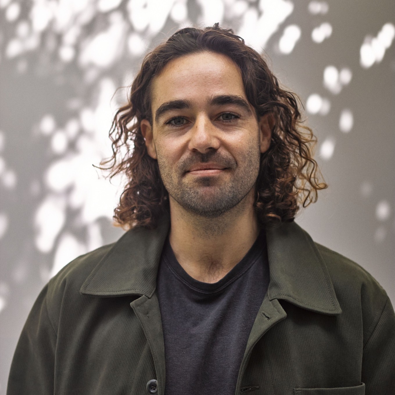 A headshot of a man in a jacket. 