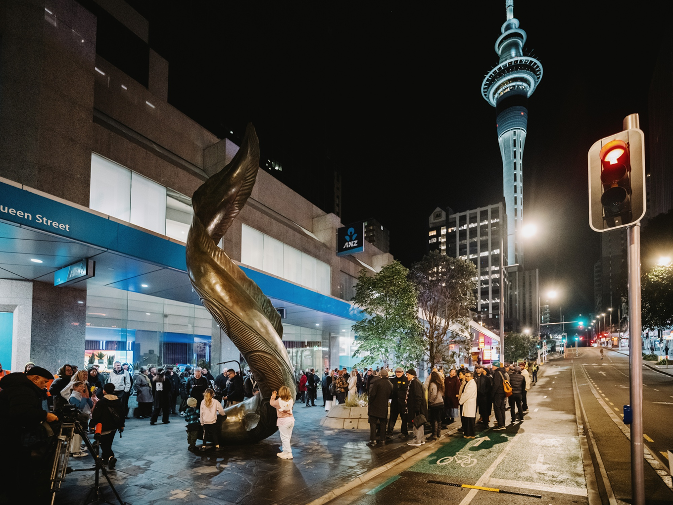 Streetside view of a dawn ceremony for the opening of a Māori art piece in the city centre.