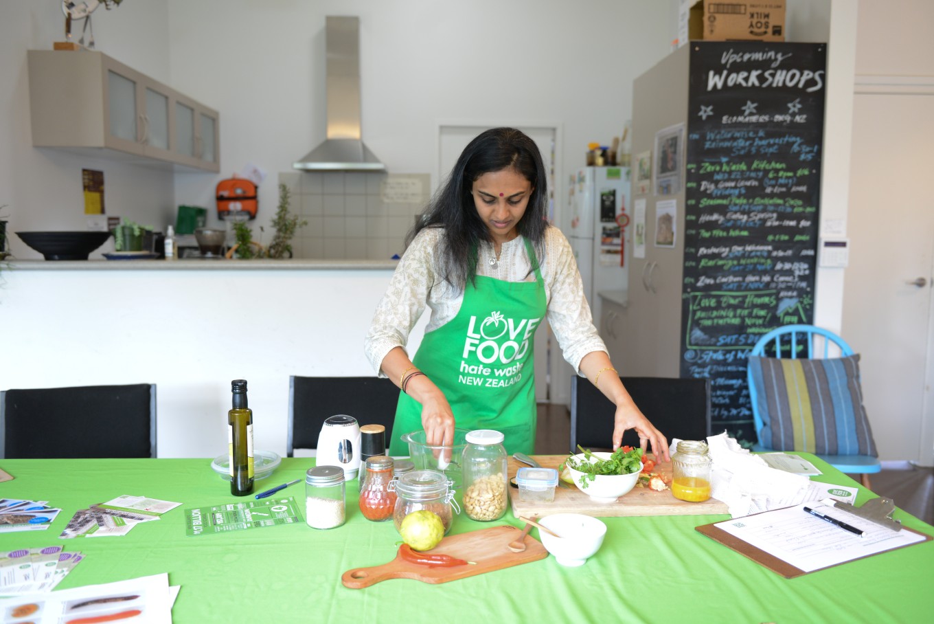 A staff member from Love Food Hate Waste preparing food. 