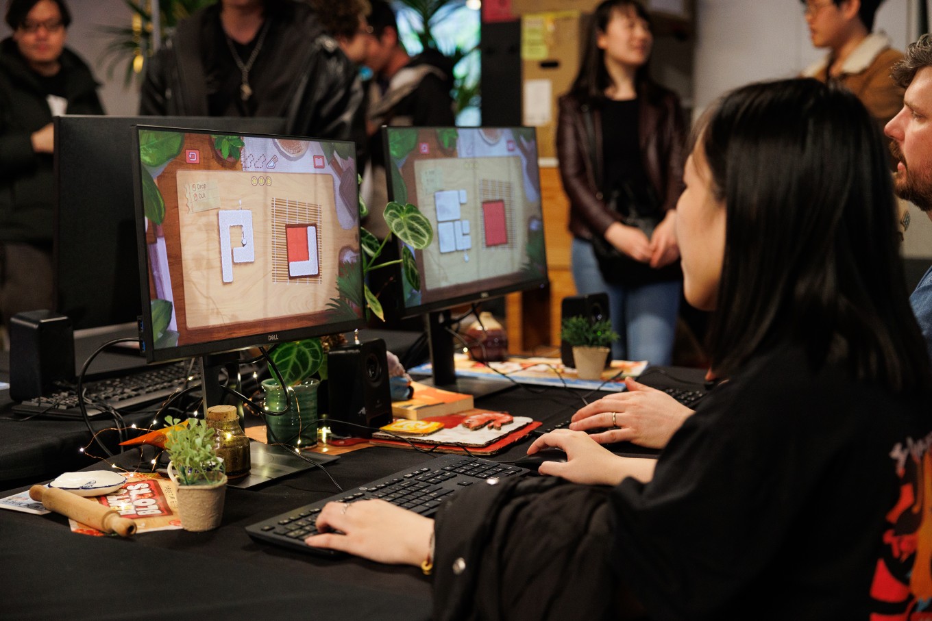 A person coding a video game on a computer. 