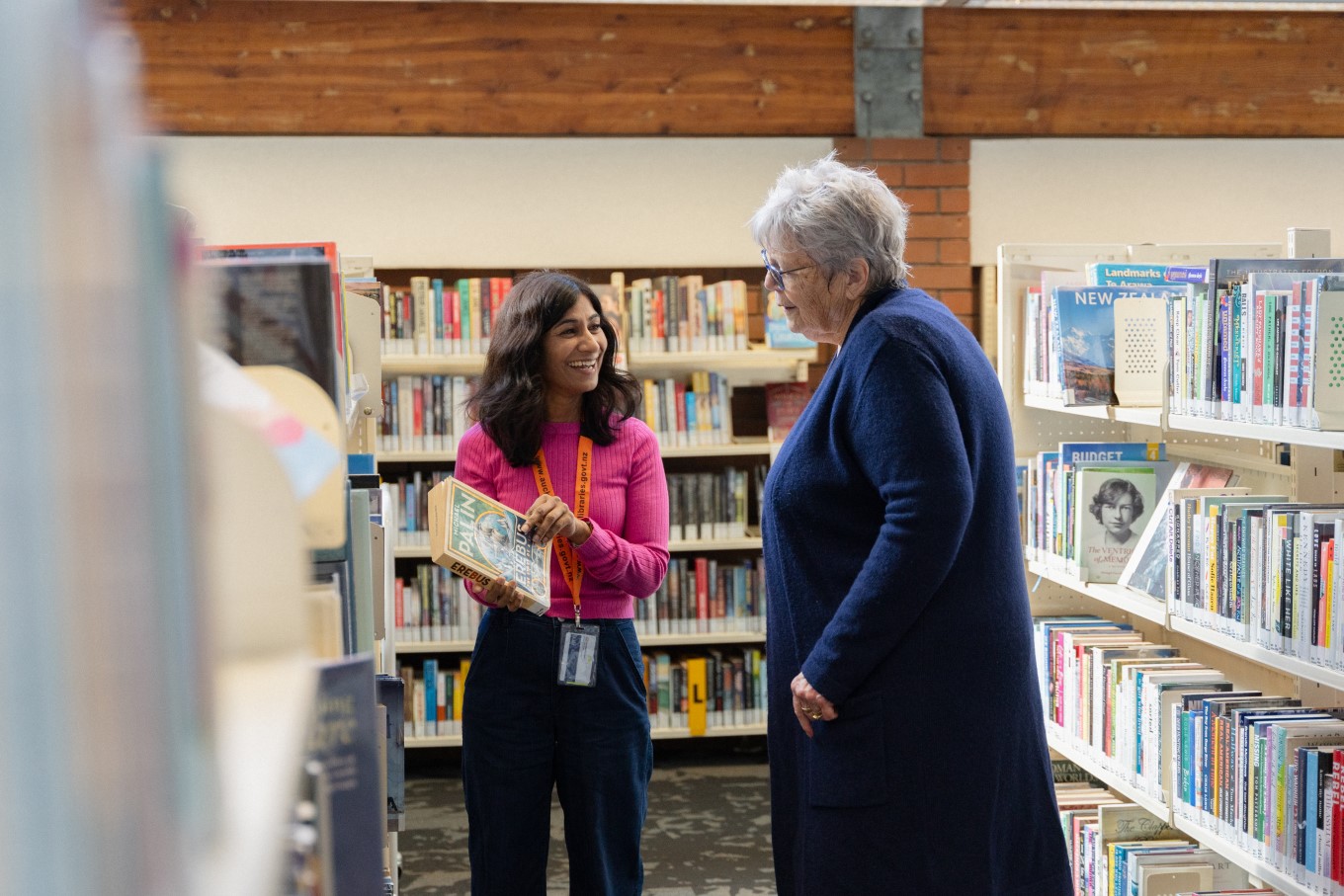 Mt Albert Library manager Kala Bhana talks books with customer Patricia Lustl.