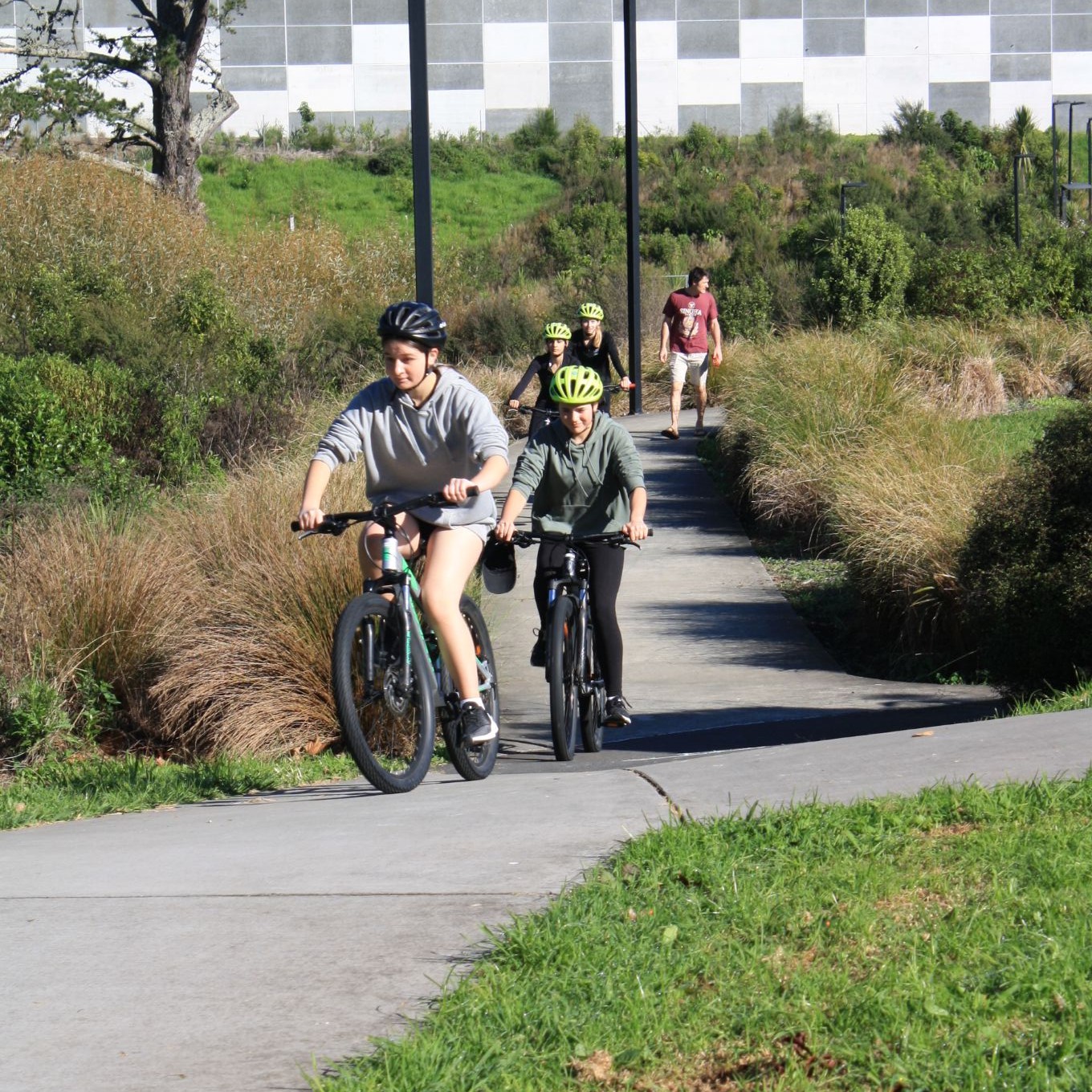 Community cyclists riding in the park.