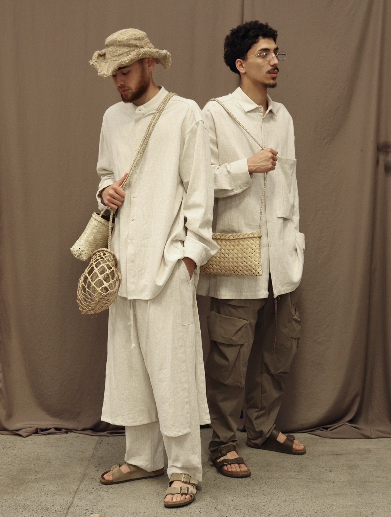 Two men dressed in indigenous led fashion which is coloured white.