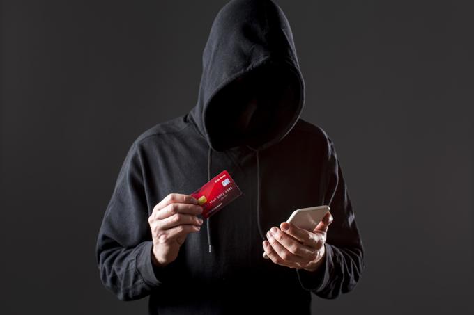 front-view-male-hacker-holding-smartphone-credit-card_ltzcn3cz.jpg