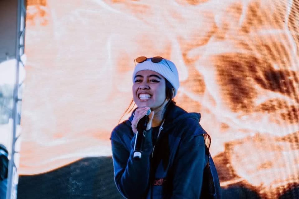 A young woman performing on a microphone. 