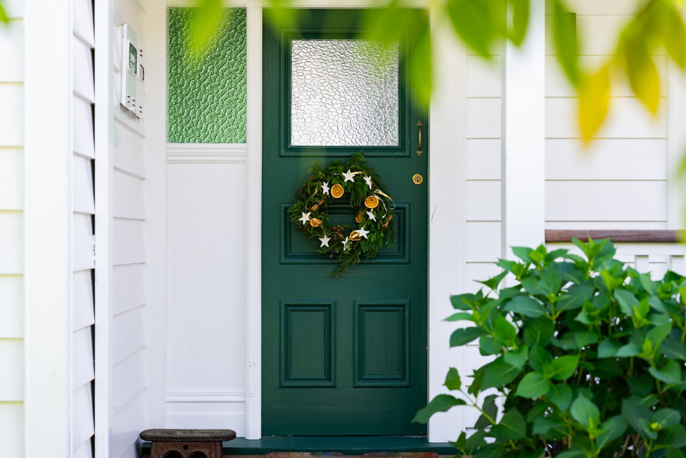 A Christmas wreath on a door of a person's house. 