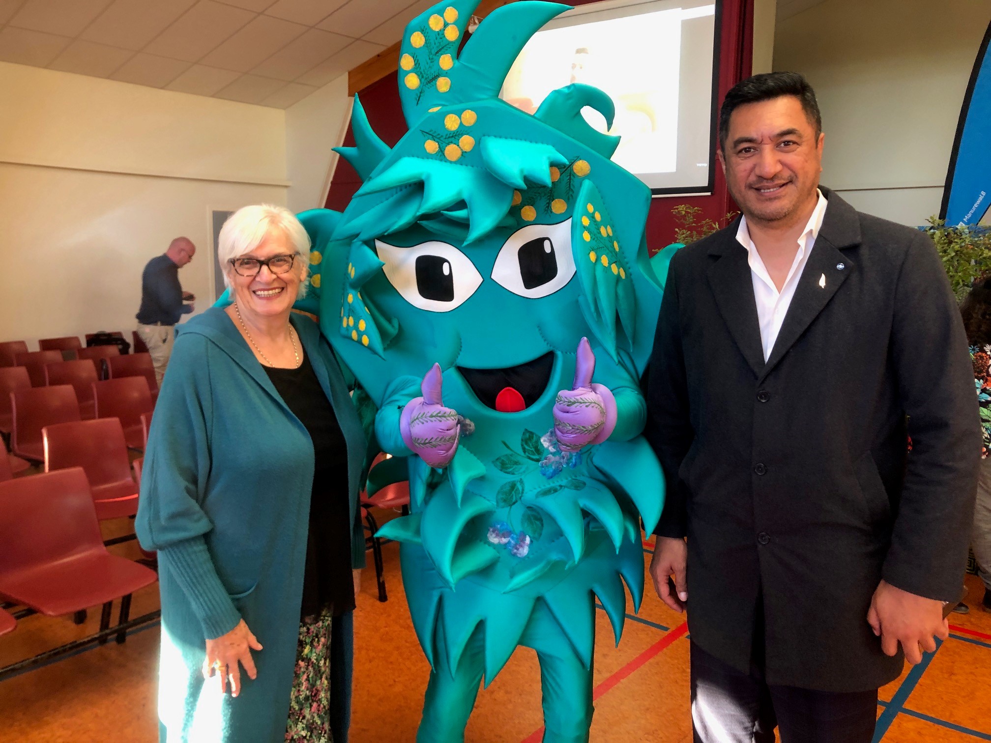 Manurewa Local Board's Anne Candy and Māngere-Ōtāhuhu chair Tauanu’u Nanai Nic Bakulich grab a selfie with the Pest Free mascot.