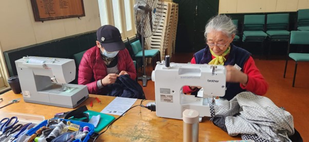 Volunteers busy with sewing alterations at Epsom Sewing Repair Cafe May 2023