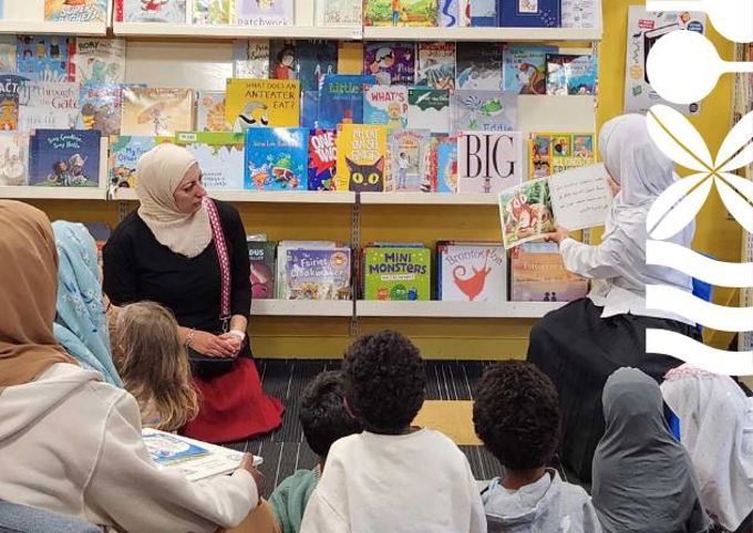 Children and two women at community book reading