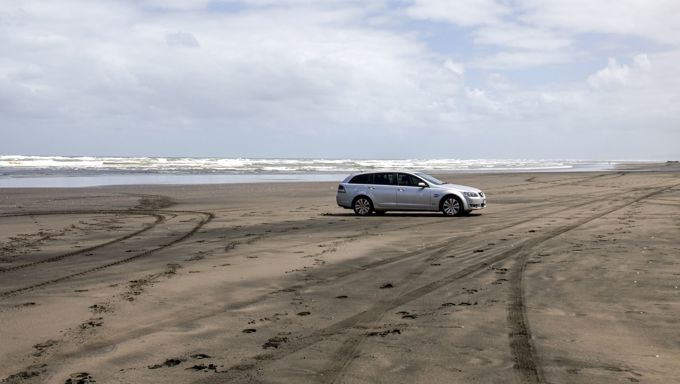 Car driving on beach