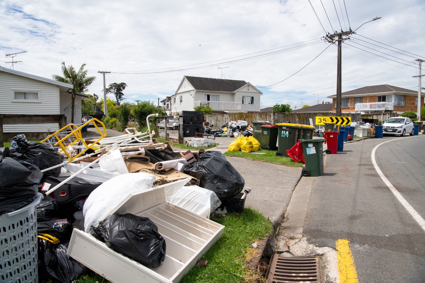 Flood-damaged household goods and waste placed for collection after severe weather in New Zealand.