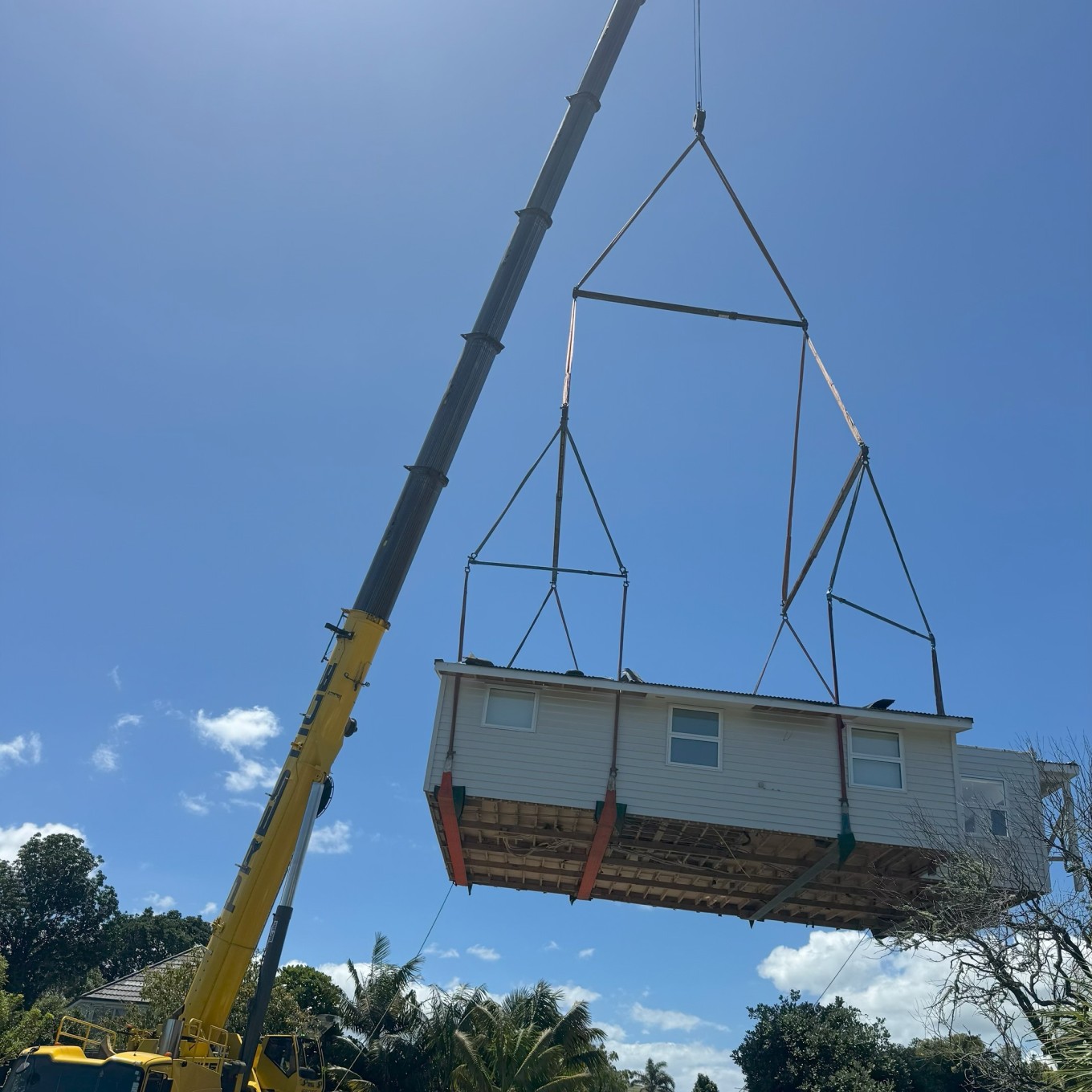 A digger removing a house.