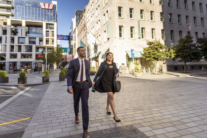 Male And Female Delegates Walking Downtown