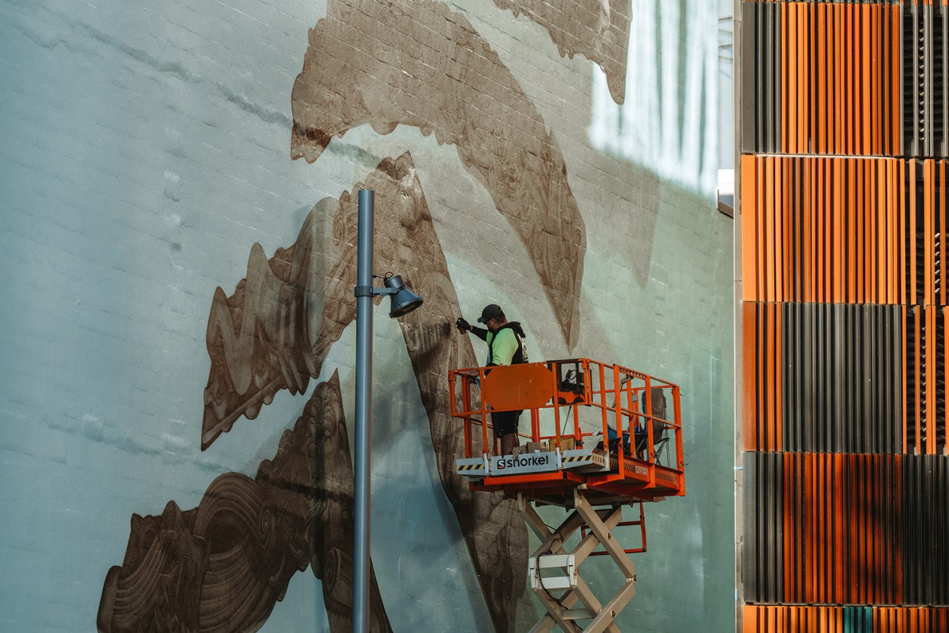 A person painting a street mural. 