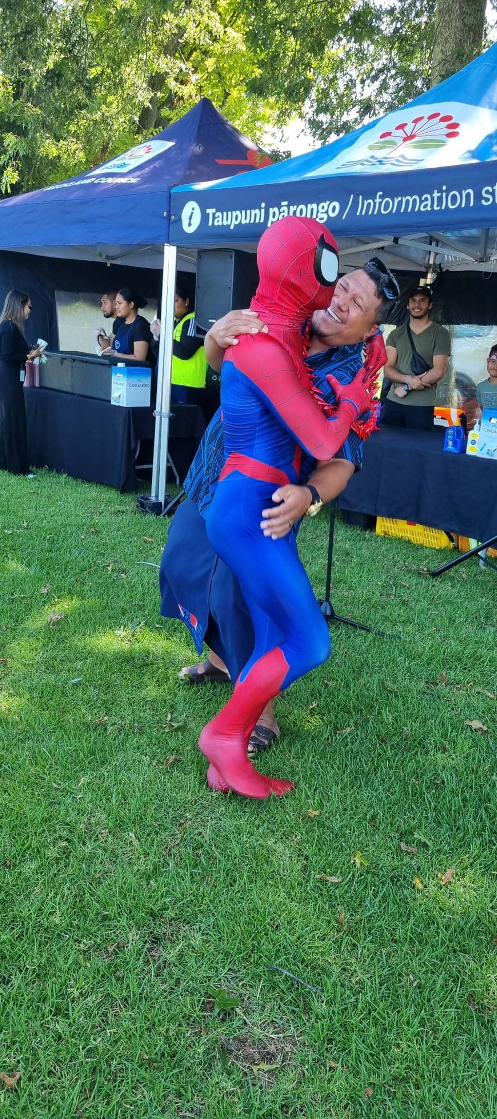 Spider man dancing with a community member