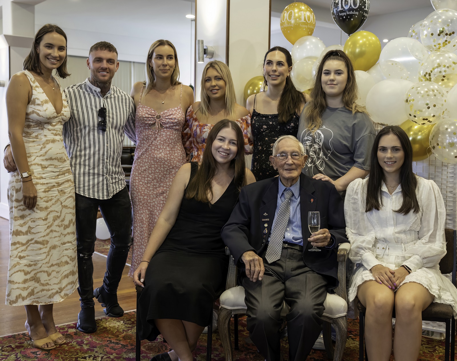 Des at his 100th birthday at Franklin RSA, Pukekohe, surrounded by his grandchildren.