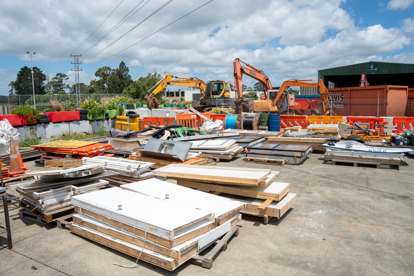 Stacks of wood being placed at a community recycling centre.