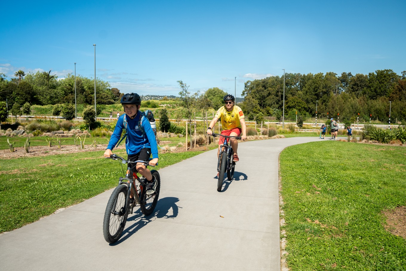 People riding their bikes on a sunny day. 