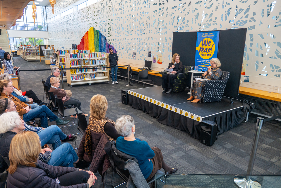 People gathered together for a reading event in their local library.