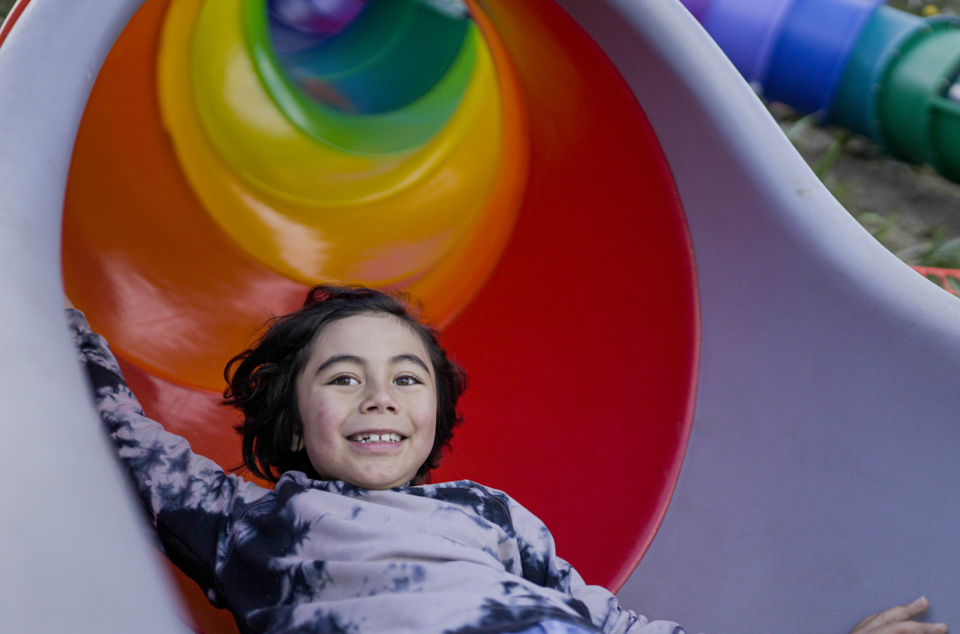 Child coming down a slide.