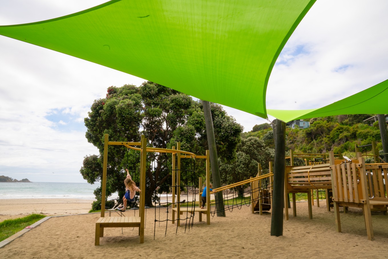 A playground with a sun cover. 