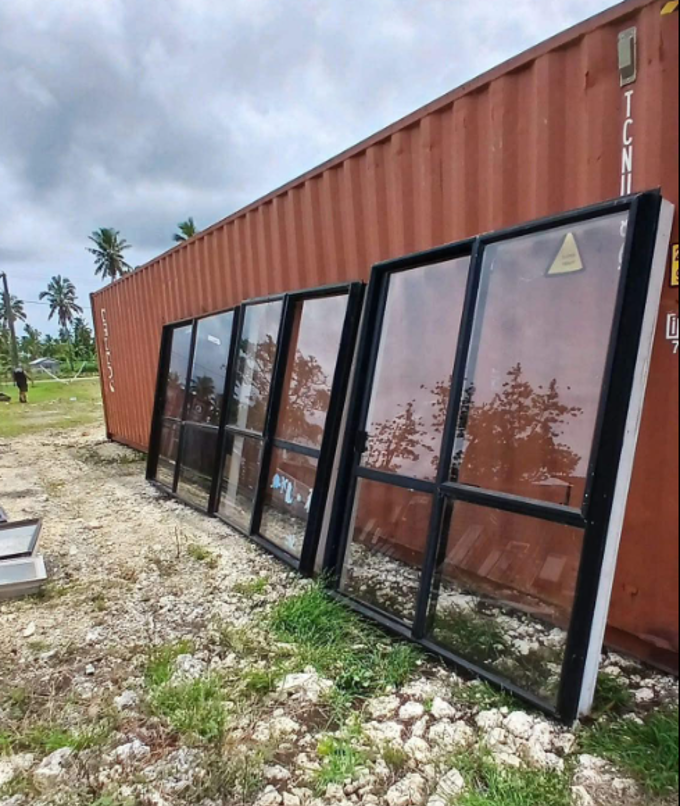 Glass windows leaning on shipping container