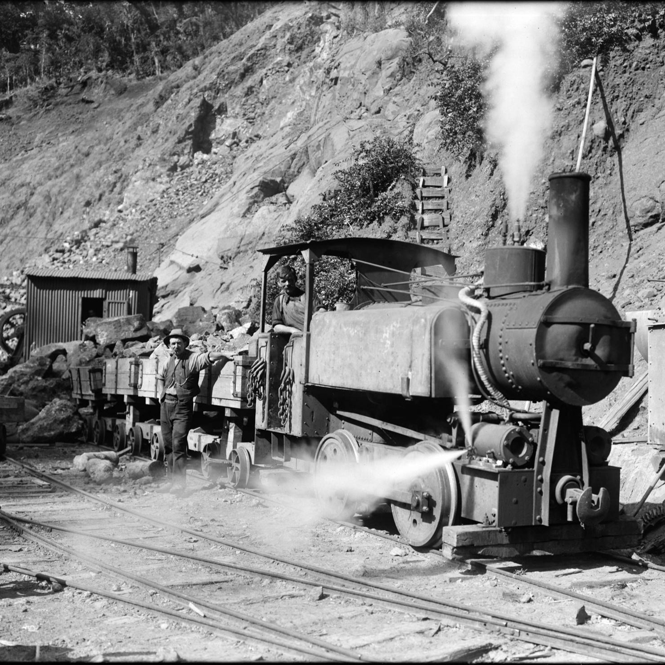 A historical image of a steam locomotive in the Wāitakere Ranges. 