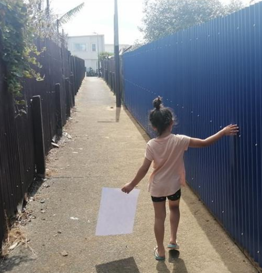 Jenna's child enjoying the beautiful blue alleyway her family help build