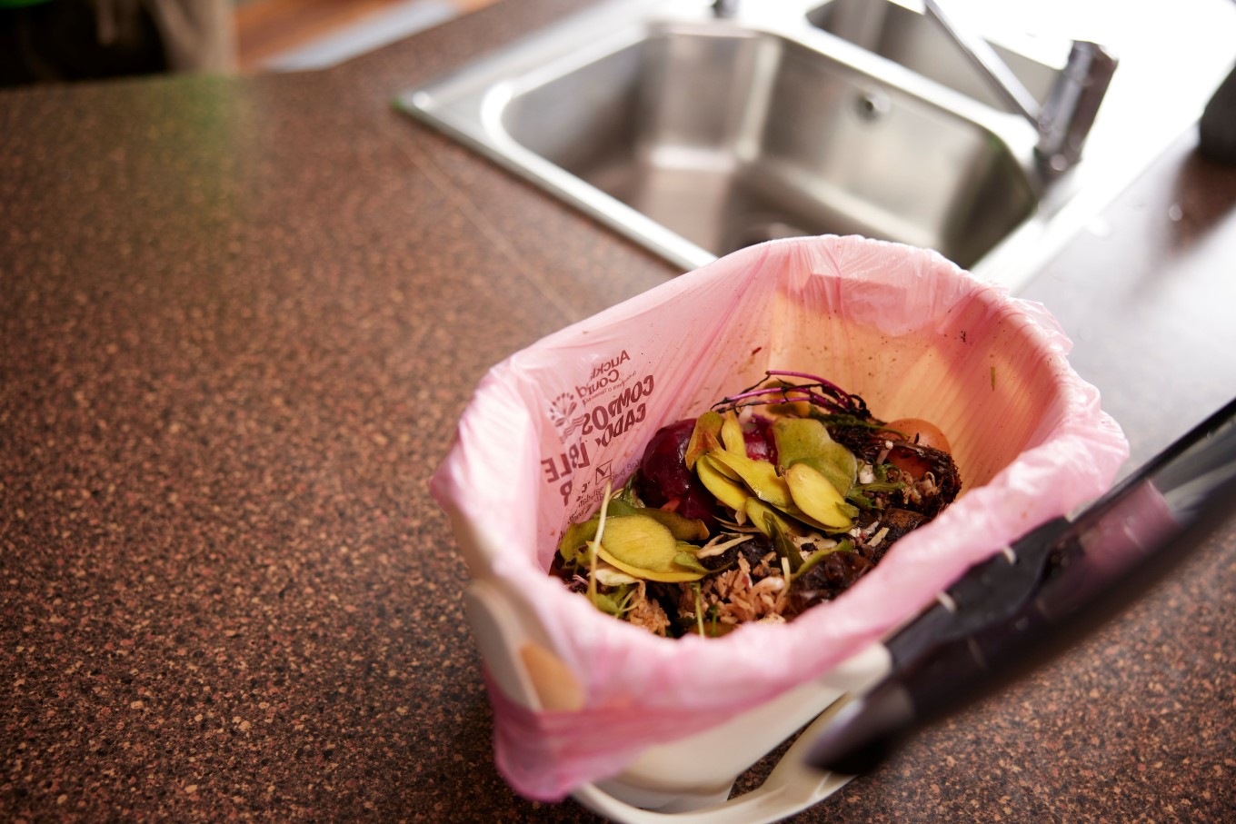 Food caddy with food scraps in it.