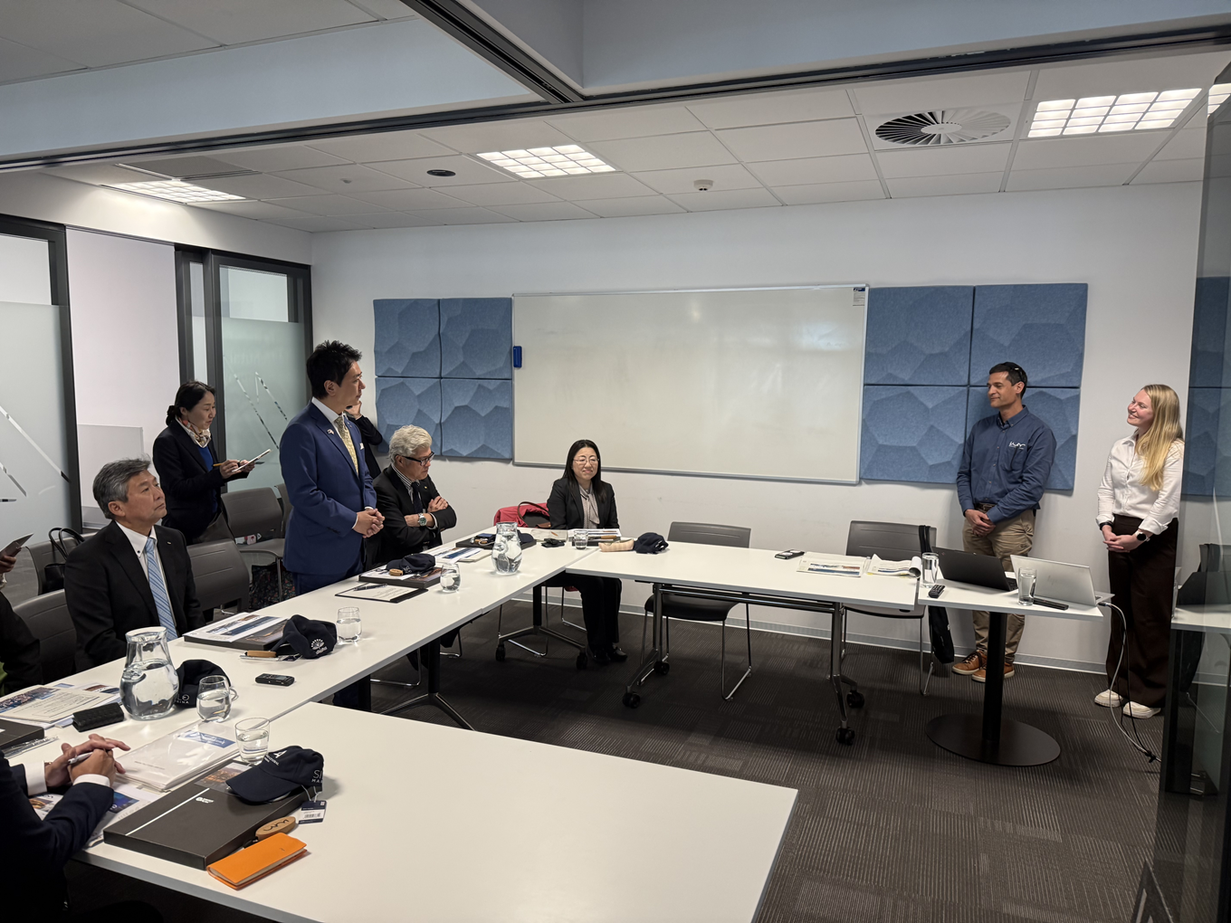 A group of people having a discussion in a boardroom. 