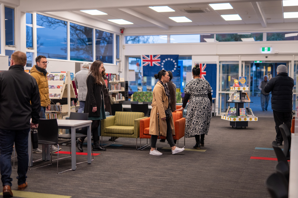 A group of people inspecting the new and improved local library. 