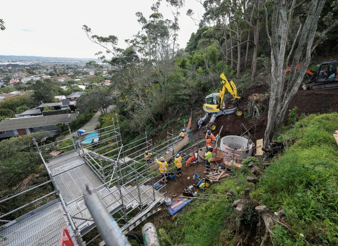 Workers working in a reservoir installing pipes. 
