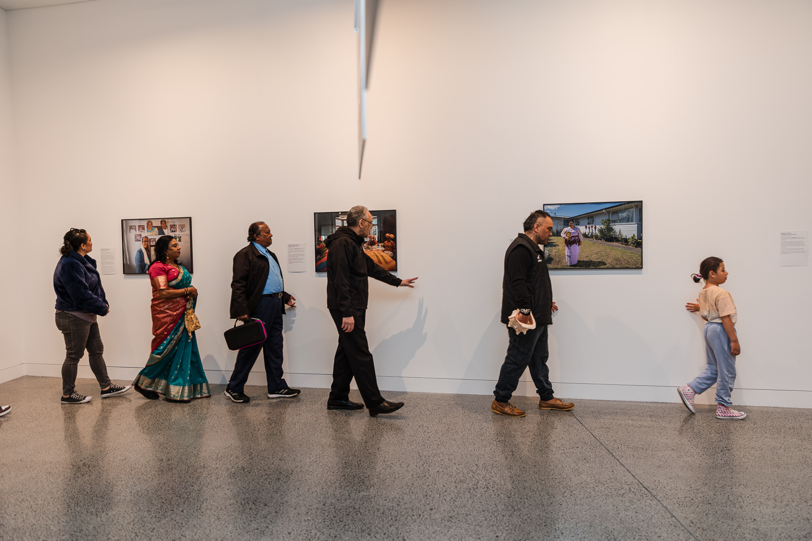 Community attending a art exhibition.