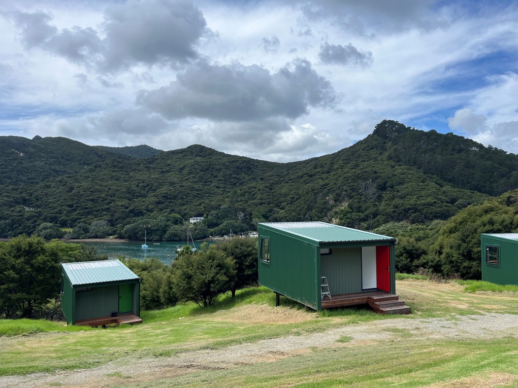 Tin shed cabins next to a lake