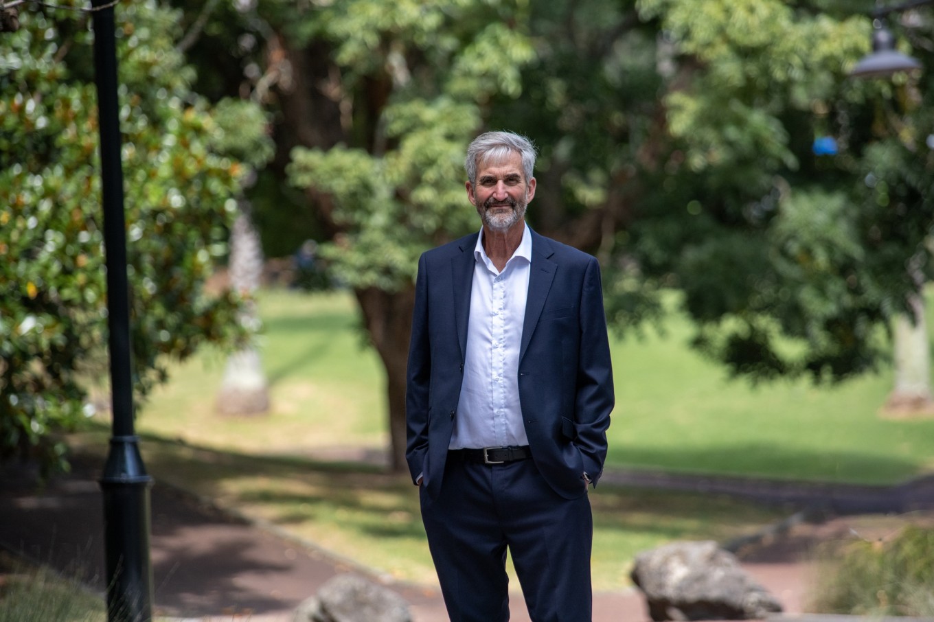 A guy in a suit in a park.